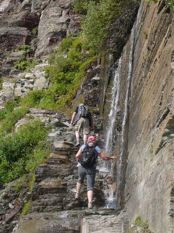 Cold water sprays on hikers, Grinnell Glacier Trail, Glacier National Park, Montana