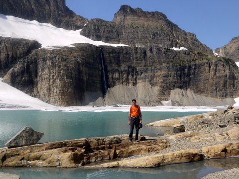 Charlie Posing in Front of Upper Grinnell Lake, with Salamander Glacier Overhead; Glacier National Park, Montana